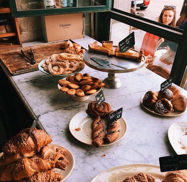 Lady looking at fresh pastries